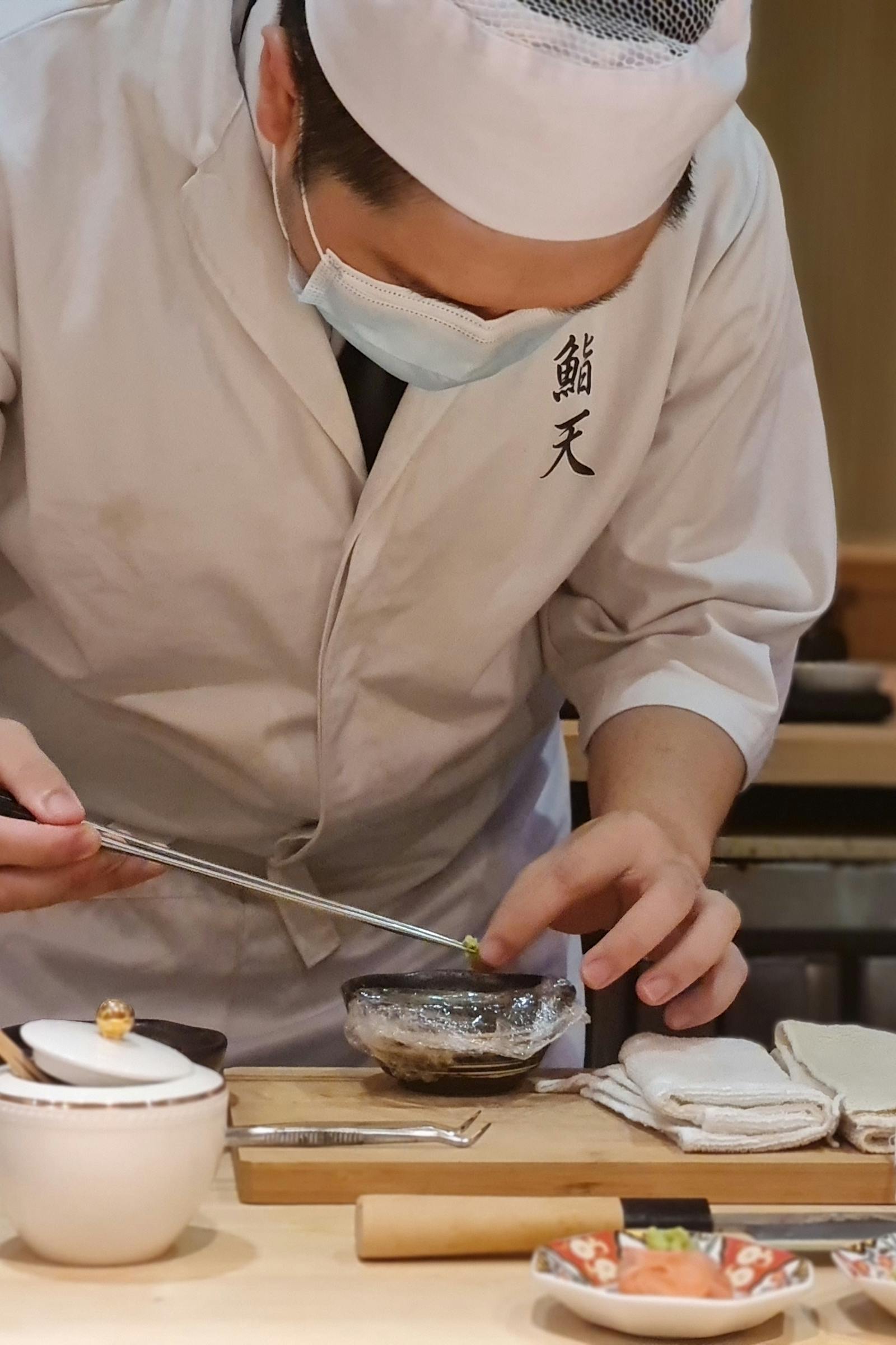 Chef slicing sashimi with deliberate precision
